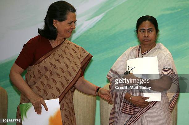 Chairperson Sonia Gandhi and Railways Minister Mamata Banerjee at the release of UPA's 'Report to The People' on completion of one year of UPA's...