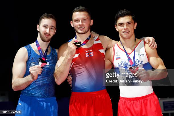 Artem Dolgopyat of Israel , Dominick Cunningham of Great Britain and Artur Dalaloyan of Russia pose for a photo with their medals after the Floor...