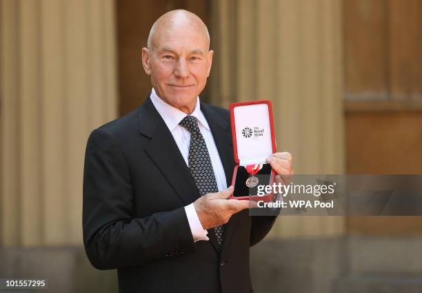 Actor Sir Patrick Stewart poses with his award after he was Knighted by Britain's Queen Elizabeth II at Buckingham PalaceJune 02, 2010 in London,...