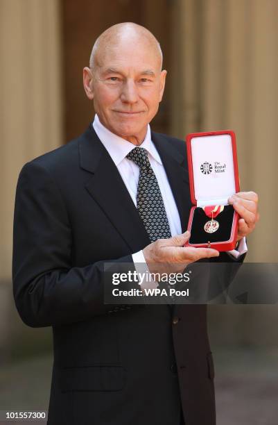 Actor Sir Patrick Stewart poses with his award after he was Knighted by Britain's Queen Elizabeth II at Buckingham PalaceJune 02, 2010 in London,...