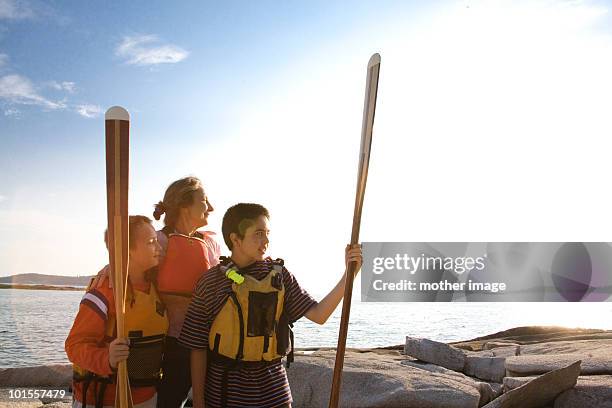 woman with sons getting ready to kayak - vinalhaven stockfoto's en -beelden