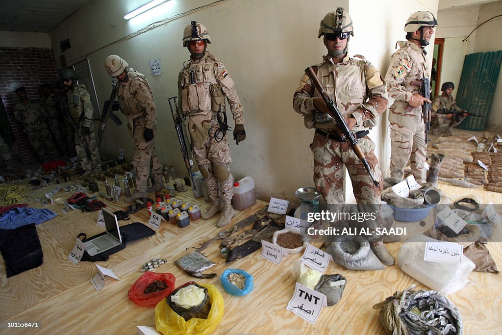 Iraqi soldiers display weapons and mater