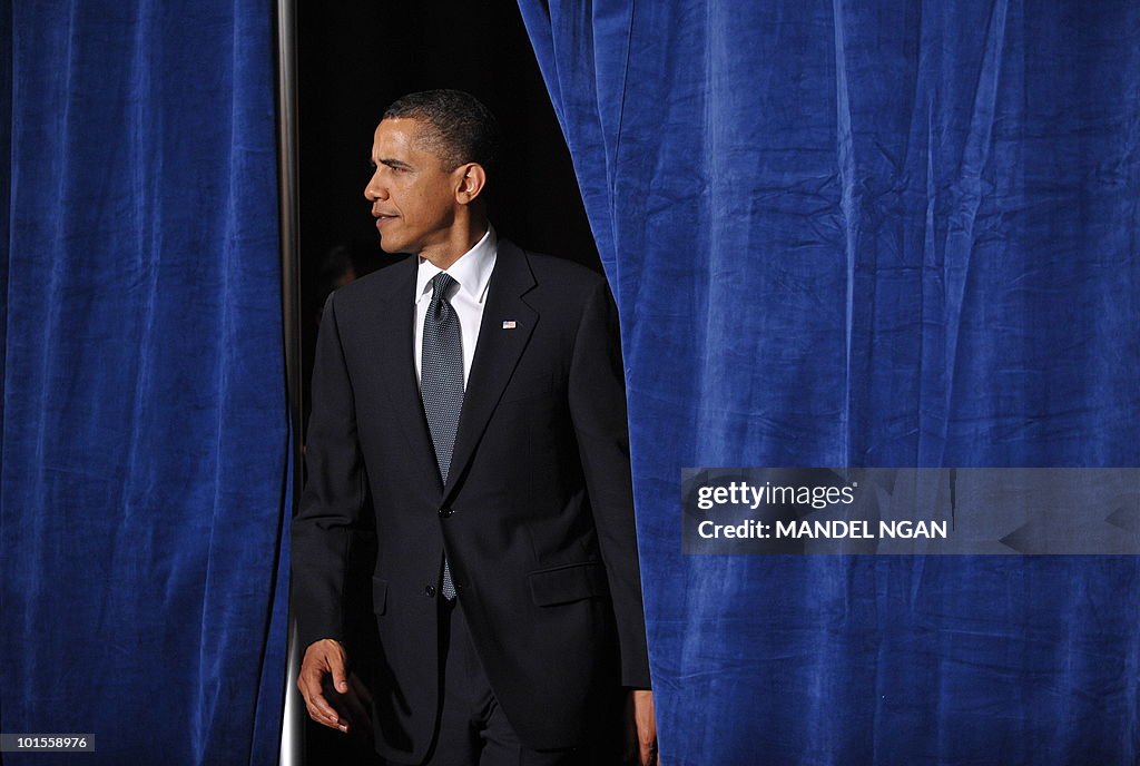 US President Barack Obama walks through