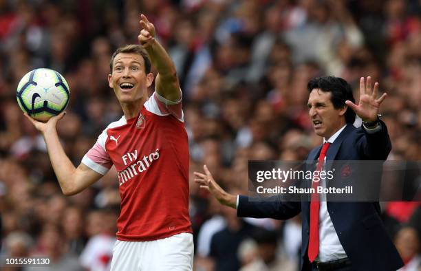 Unai Emery, Manager of Arsenal gestures as Stephan Lichtsteiner of Arsenal prepares to take a throw during the Premier League match between Arsenal...