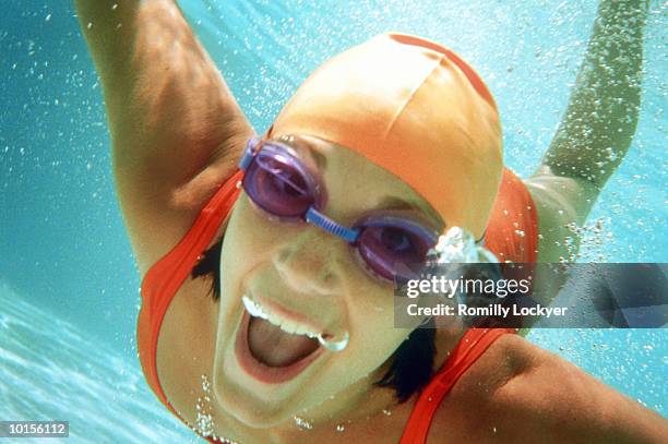 young woman swimming underwater - simglasögon bildbanksfoton och bilder