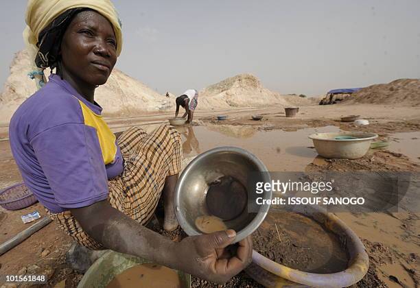 Recent picture showing a woman sifting through mud as she looks for gold on the site of Namisgma, some 200 kilometers from Ouagadougou, Northern...