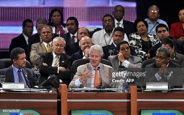 Former US president and special UN representative for Haiti Bill Clinton speaks next to the president of Dominican Republic Leonel Fernandez and the...