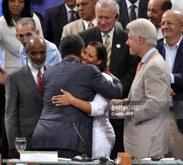 Sonia Marmolejos , a woman who helped Haitian children, is congratulated by the president of Dominican Republic Leonel Fernandez, after she was...