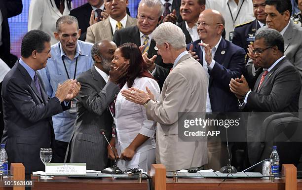 Sonia Marmolejos , a woman who helped Haitian children is congratulated by former president of Haiti Rene Preval after she was awarded with the...