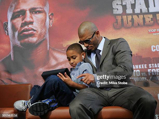 Miguel Cotto and his son Miguel Jr. Look on prior to the start of the Foreman v Cotto press conference on June 2, 2010 at Yankee Stadium in the Bronx...