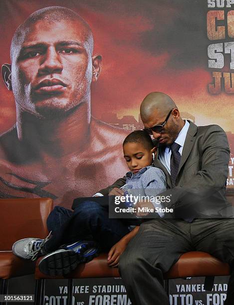 Miguel Cotto and his son Miguel Jr. Look on prior to the start of the Foreman v Cotto press conference on June 2, 2010 at Yankee Stadium in the Bronx...