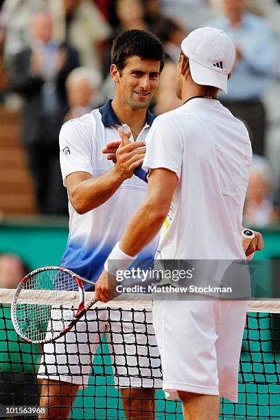 Jurgen Melzer of Austria shakes hands with Novak Djokovic of Serbia after winning the men's singles quarter final match between Novak Djokovic of...