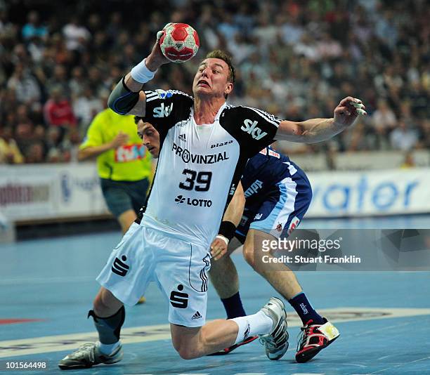 Filip Jicha of Kiel is challenged by Vladimir Temelkov of Balingen during the Toyota Handball bundesliga match between THW Kiel and HBW...