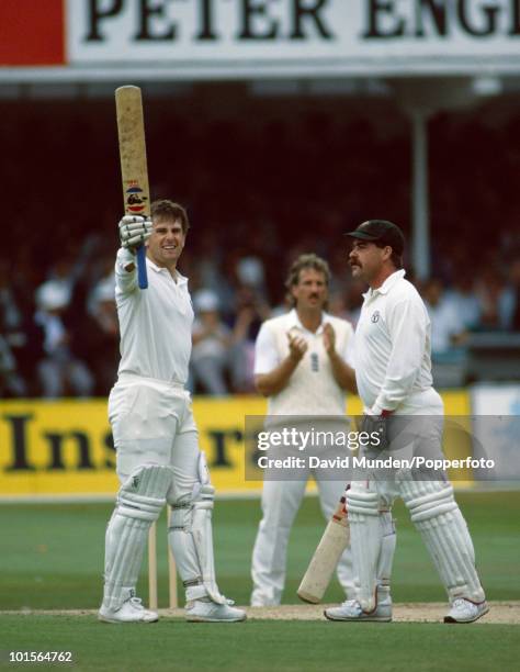 Mark Taylor holds his bat aloft and is congratualted by David Boon after reaching 200 for Australia on the second day of the 5th Test match between...