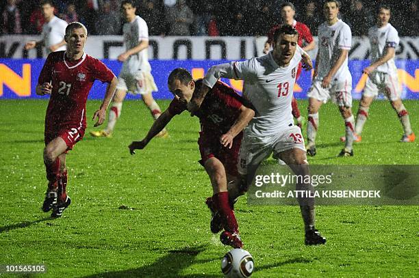 Serbia's Aleksandar Lukovic fights for the ball with Poland's Adrian Mierzejewski during their friendly match in the local stadium of Kufstein on...