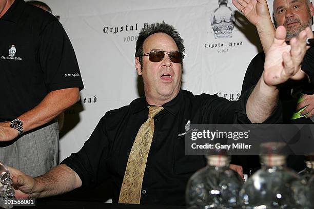 Actor Dan Aykroyd signs bottles of his Crystal Head Vodka at Twin Liquors on May 10, 2010 in Austin, Texas.