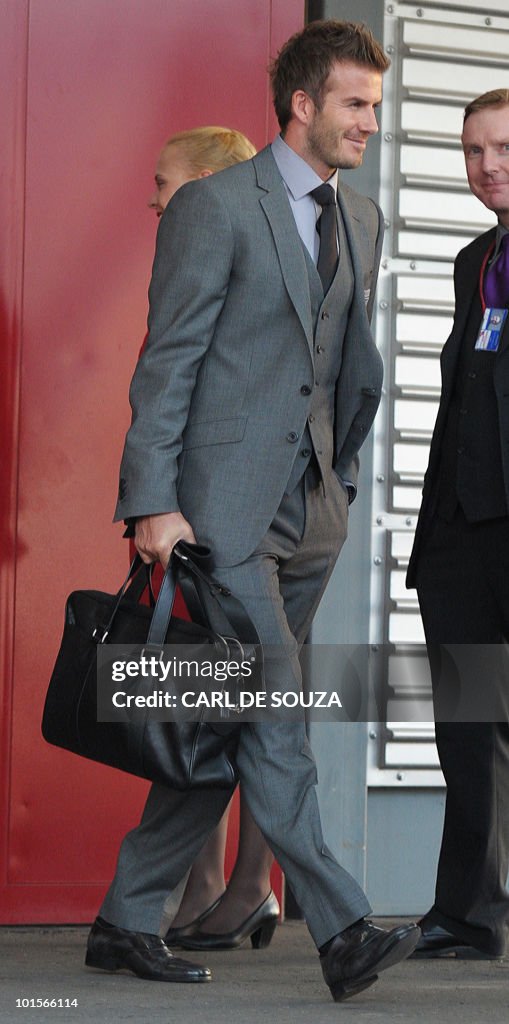 David Beckham walks towards a plane befo