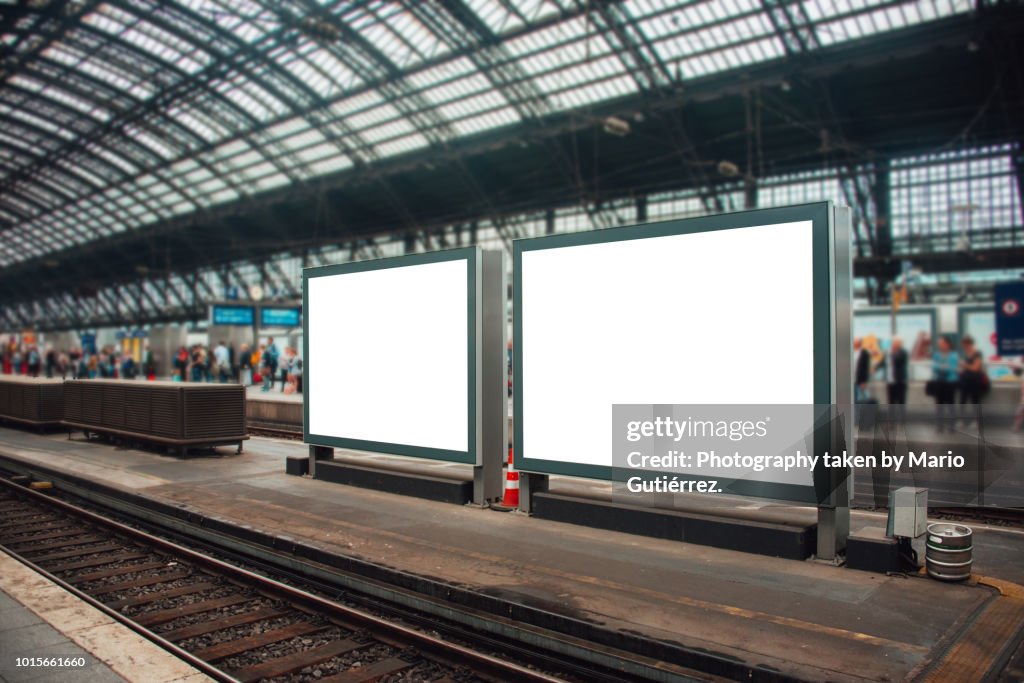 Two blank billboards at railroad station