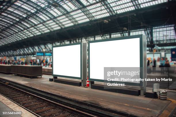 two blank billboards at railroad station - placard foto e immagini stock