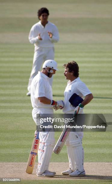 England captain Graham Gooch congratulates Allan Lamb on reaching his century on the first day of the 1st Test Match between England and India at...