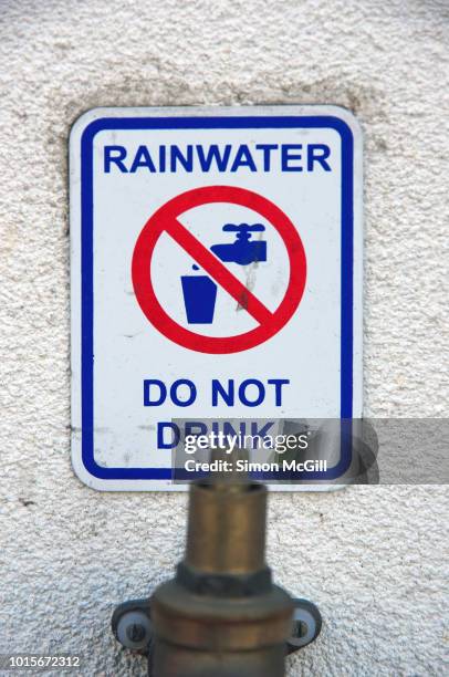 'rainwater: do not drink' sign above a rainwater pipe - no drinking stock pictures, royalty-free photos & images