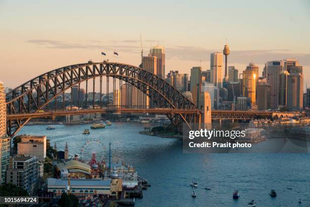 cityscape image of sydney, australia with harbour bridge and sydney skyline during sunset. - north sydney stock pictures, royalty-free photos & images