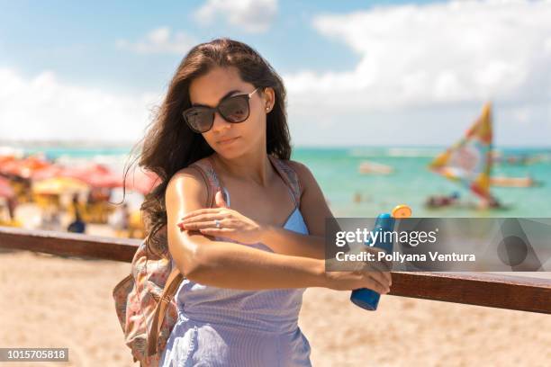 woman applying sunblock protection on porto de galinhas beach in tamandaré, pernambuco, brazil - hot body pic stock pictures, royalty-free photos & images