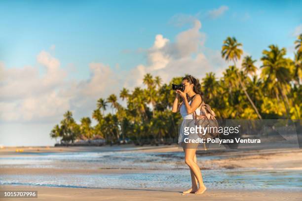 tourist on carneiros beach in tamandaré, pernambuco, brazil - camera boat stock pictures, royalty-free photos & images