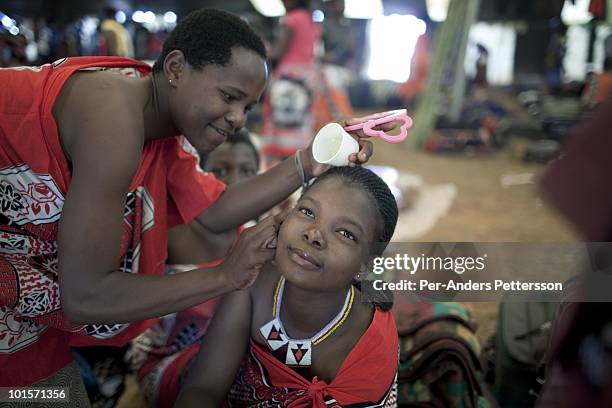Unidentified girls dress and prepare before a traditional Reed dance ceremony at the Royal Palace on August 30 in Ludzidzini, Swaziland. About 80.000...
