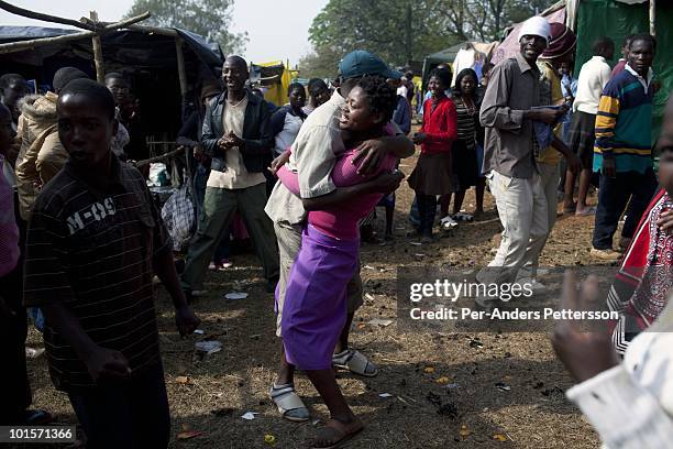 Young woman dances with an older boy during a traditional Reed dance ceremony at the stadium at the Royal Palace on August 30 in Ludzidzini,...