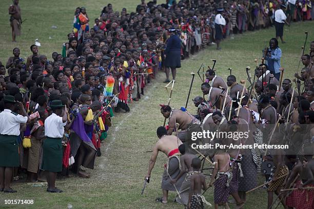King Mswati III dances in front of young virgins at a traditional Reed dance ceremony at the stadium at the Royal Palace on August 31 in Ludzidzini,...