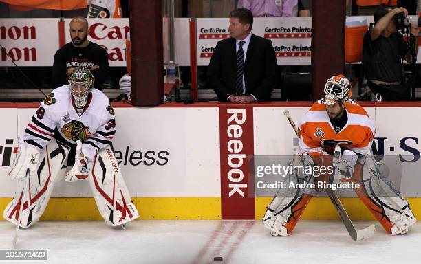 Goaltenders Cristobal Huet of the Chicago Blackhawks and Michael Leighton of the Philadelphia Flyers stand on the ice during warm-ups in Game Three...