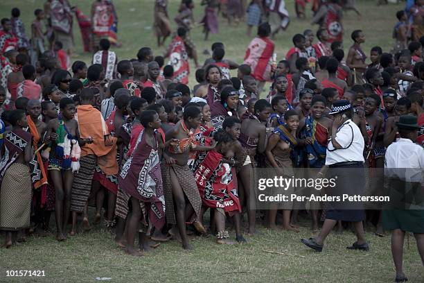 Police control young girls at a traditional Reed dance ceremony at the stadium at the Royal Palace on August 31 in Ludzidzini, Swaziland. About...