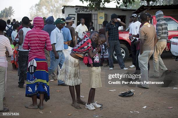 Young girls relax at an outdoor entertainment areas while attending a traditional Reed dance ceremony relaxes in a village close to the Royal Palace...