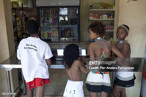 Unidentified children buy snacks at a shop at the Royal Palace on August 31 in Ludzidzini, Swaziland. About 80.000 virgins from all over the country...