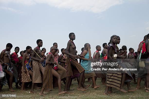 Young girls dance at a traditional Reed dance ceremony at the stadium at the Royal Palace on August 31 in Ludzidzini, Swaziland. About 80.000 virgins...