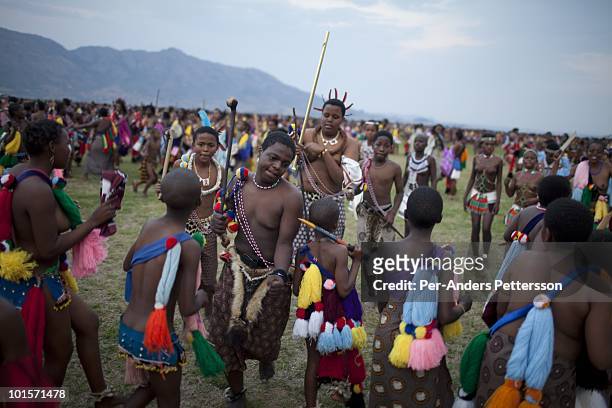 Children of King Mswati III dances in front of young virgins at a traditional Reed dance ceremony at the stadium at the Royal Palace on August 30 in...