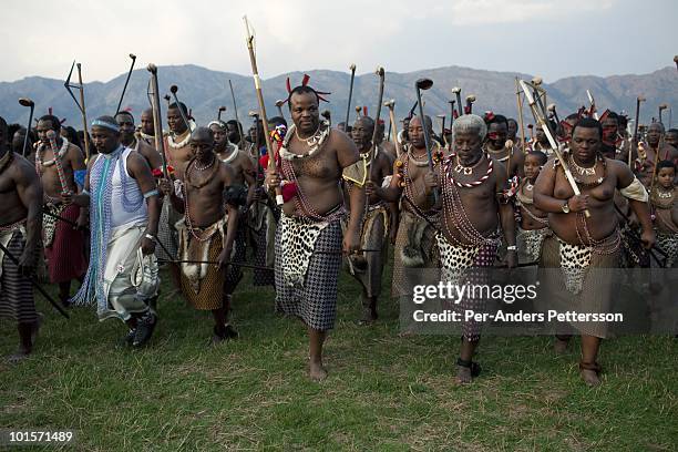 King Mswati III dances in front of young virgins at a traditional Reed dance ceremony at the stadium at the Royal Palace on August 30 in Ludzidzini,...