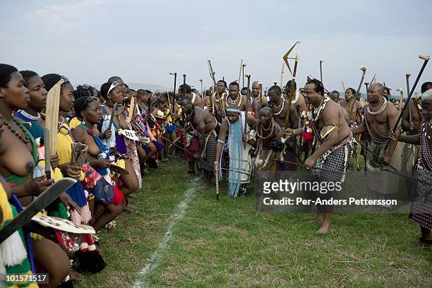 King Mswati III dances in front of young virgins at a traditional Reed dance ceremony at the stadium at the Royal Palace on August 30 in Ludzidzini,...