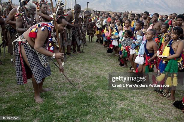 King Mswati III dances in front of young virgins at a traditional Reed dance ceremony at the stadium at the Royal Palace on August 30 in Ludzidzini,...