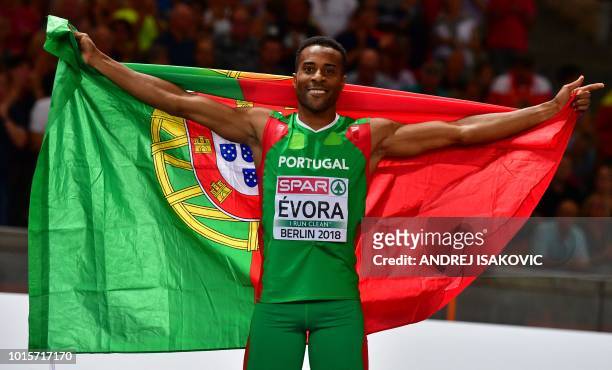 Portugal's Nelson Evora celebrates with his national flag after winning the men's Triple Jump final during the European Athletics Championships at...
