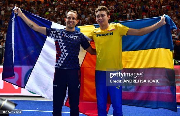 Sweden's Armand Duplantis and France's Renaud Lavillenie pose with their national flags after the men's Pole Vault final during the European...