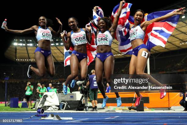 Asha Philip, Imani Lansiquot, Bianca Williams and Dina Asher-Smith of Great Britain celebrate winning gold competes in the Women's 4x100 metres relay...