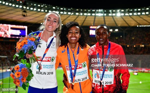Great Britain's Eilish McColgan , Netherlands' Sifan Hassan and Turkey's Yasemin Can celebrate on the podium during the medal ceremony for the...