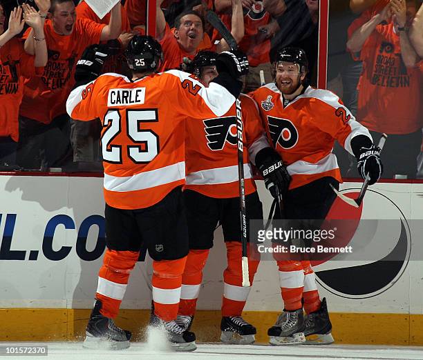 Matt Carle, Danny Briere and Claude Giroux of the Philadelphia Flyers celebrate after Briere scored a goal in the first period against the Chicago...