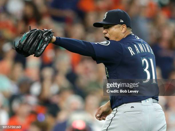 Erasmo Ramirez of the Seattle Mariners points to his catcher after getting out of a bases loaded situation in the fifth inning against the Houston...