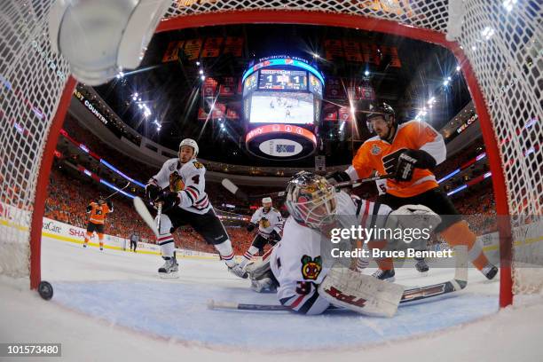 Simon Gagne of the Philadelphia Flyers scores a goal against Antti Niemi of the Chicago Blackhawks in the second period as Niklas Hjalmarsson and...