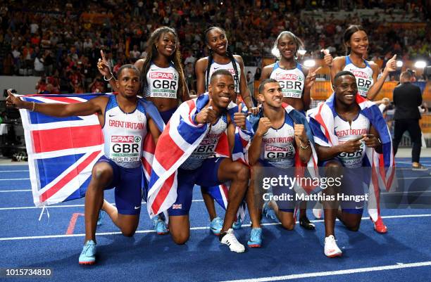 Great Britain athletes celebrate winning gold in their respective 4x100 metres relay finals during day six of the 24th European Athletics...