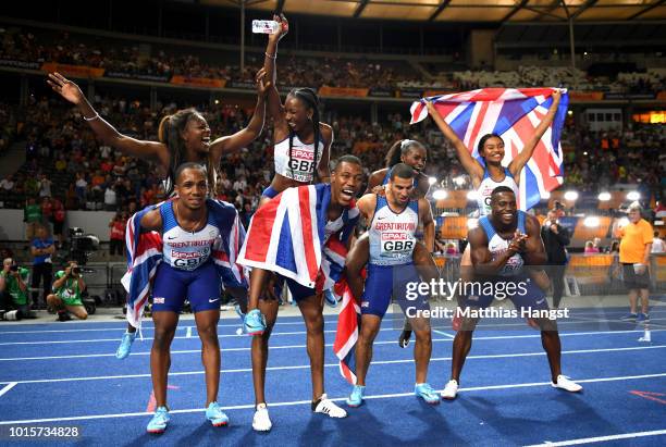 Great Britain athletes celebrate winning gold in their respective 4x100 metres relay finals during day six of the 24th European Athletics...