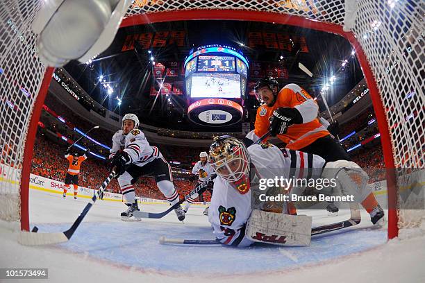 Simon Gagne of the Philadelphia Flyers scores a goal against Antti Niemi of the Chicago Blackhawks in the second period as Niklas Hjalmarsson of the...